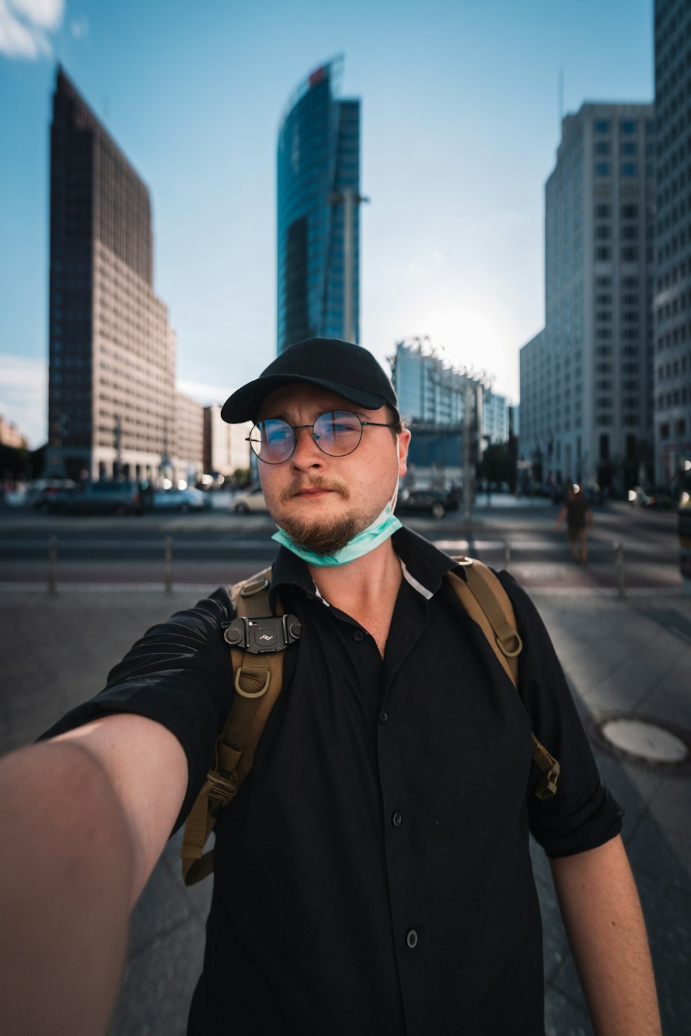 a man in a black shirt and a black hat