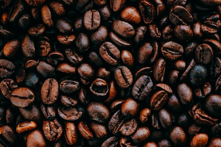 A close-up view of roasted coffee beans with rich textures and deep brown hues.