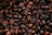A close-up view of roasted coffee beans with rich textures and deep brown hues.