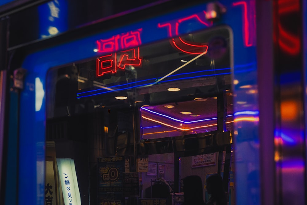 a store front with a neon sign on it
