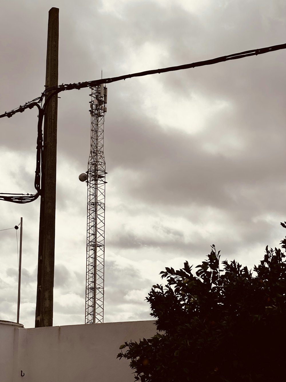 a telephone pole with a cell phone on top of it