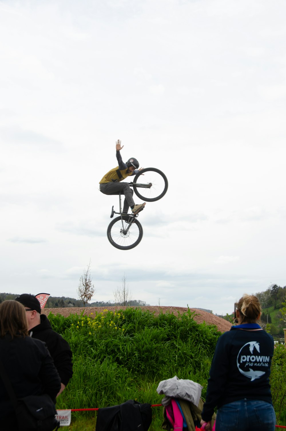 a man flying through the air while riding a bike