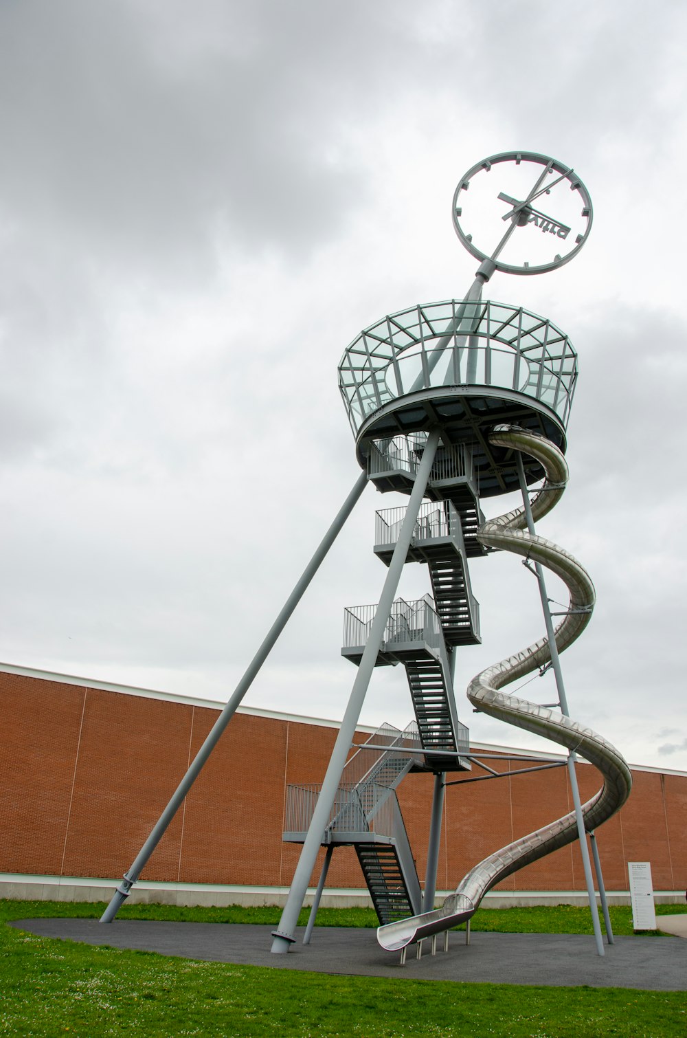 a large metal structure with a clock on top of it
