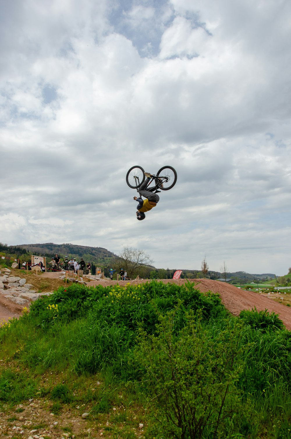 a man flying through the air while riding a bike