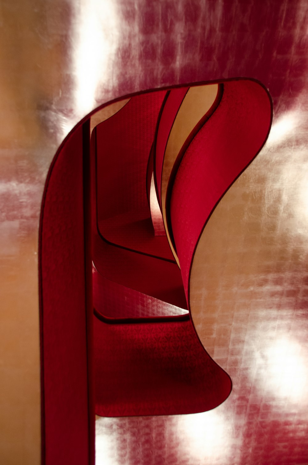 a close up of a red sculpture with a red background