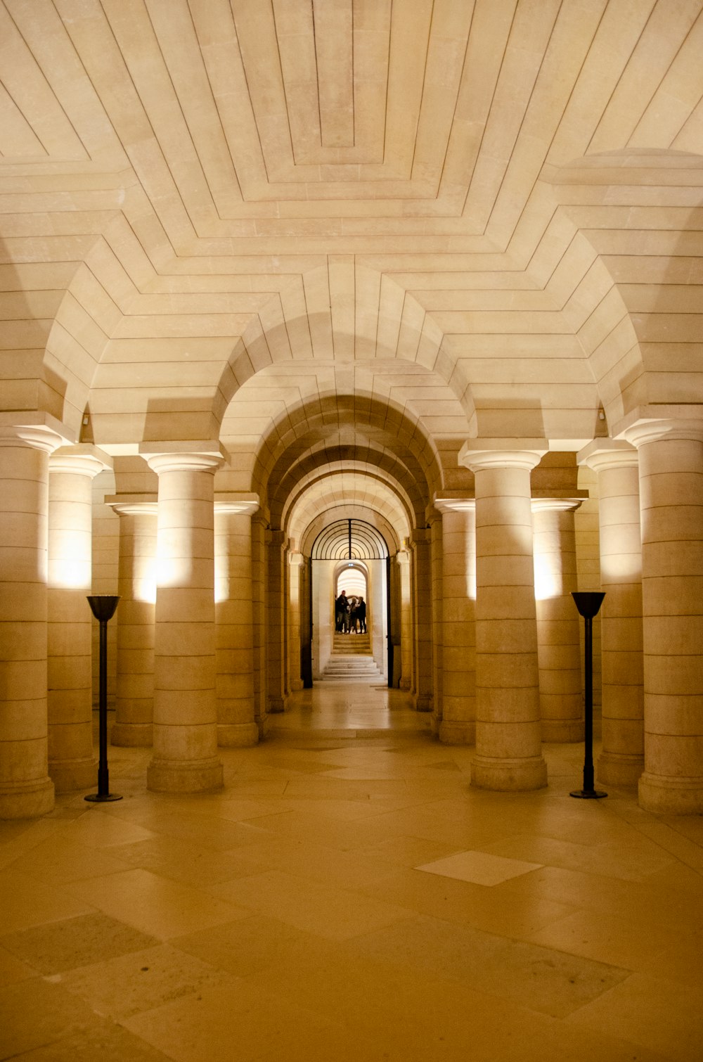 a very long hallway with some lights on either side of it