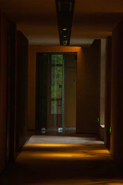 Room entrance with stylish wooden door and soft hallway lighting.