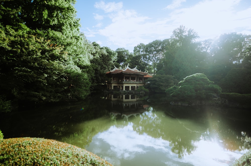 a pond with a pavilion in the middle of it