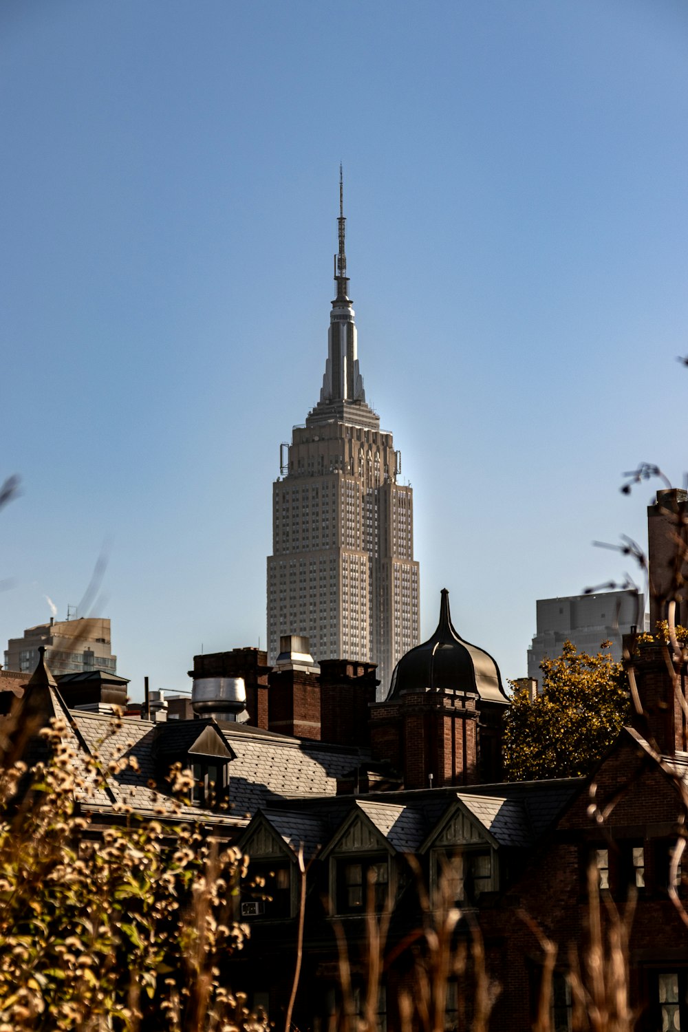 a tall building with a spire in the middle of a city