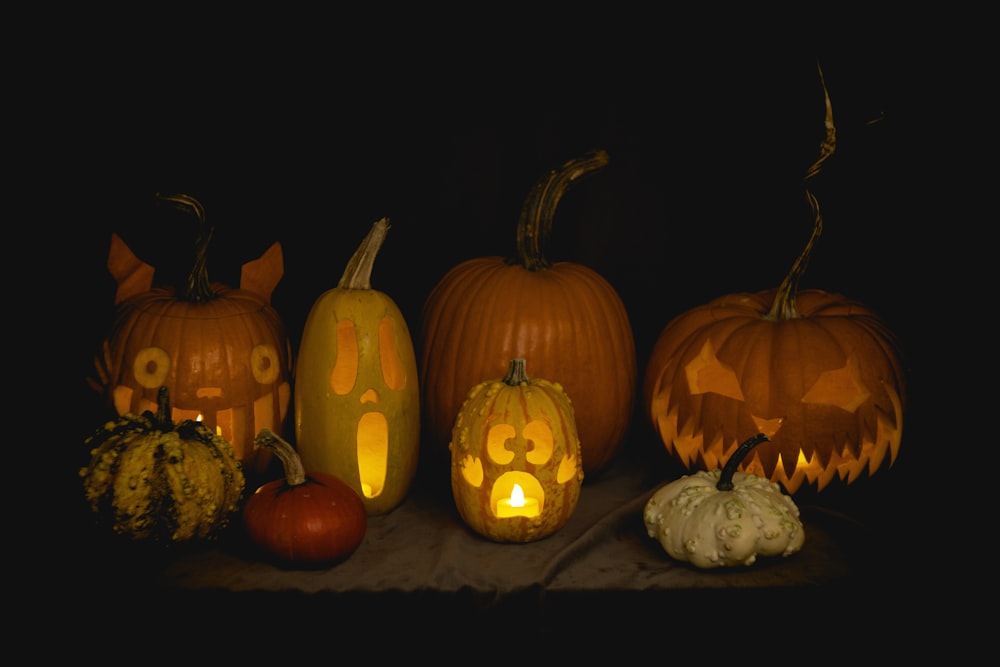 a group of carved pumpkins sitting on top of a table