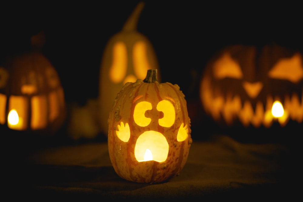 a group of carved pumpkins with faces carved into them