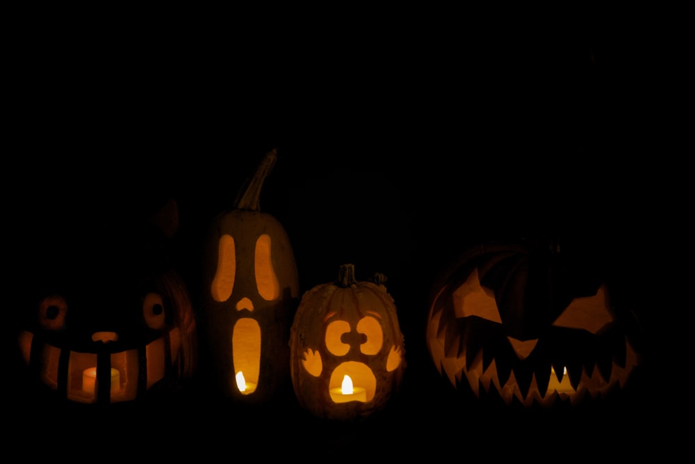 a group of carved pumpkins sitting on top of a table