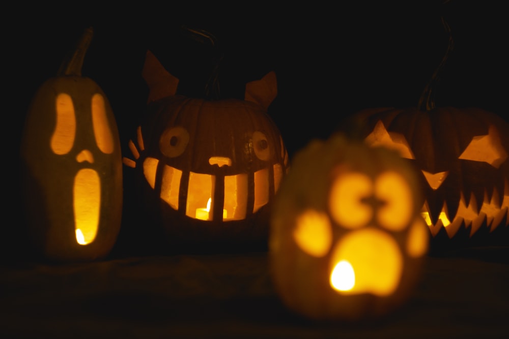 a group of pumpkins with faces carved into them