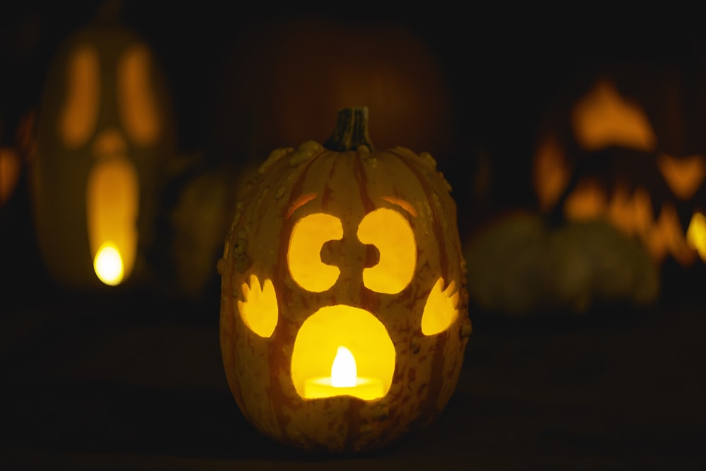 a carved pumpkin with a paw print on it