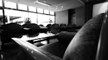 Sophisticated black and white image of a serene hotel lounge corner featuring subtle ambient scents in use.