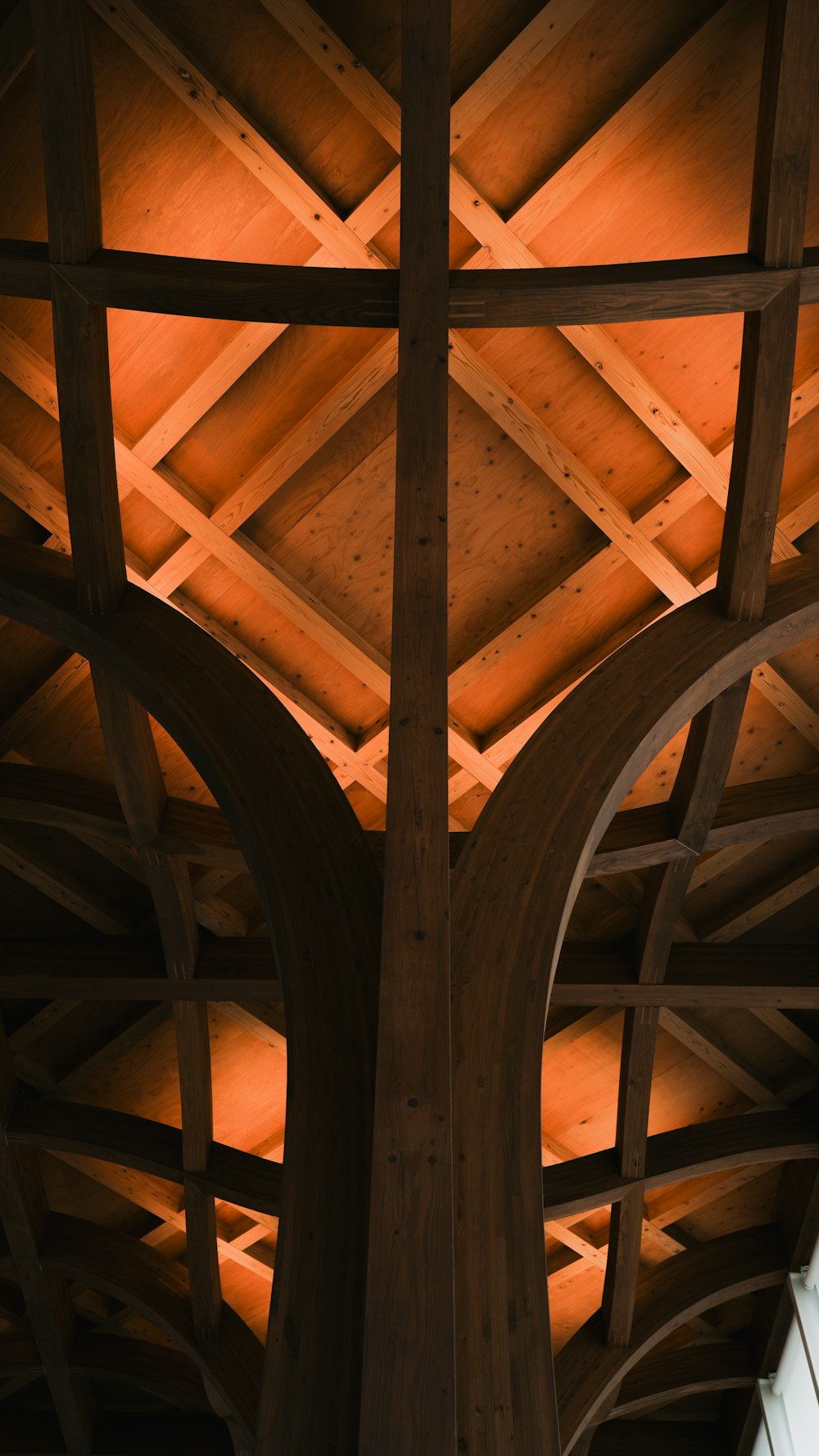 a close up of a wooden structure with a clock on it