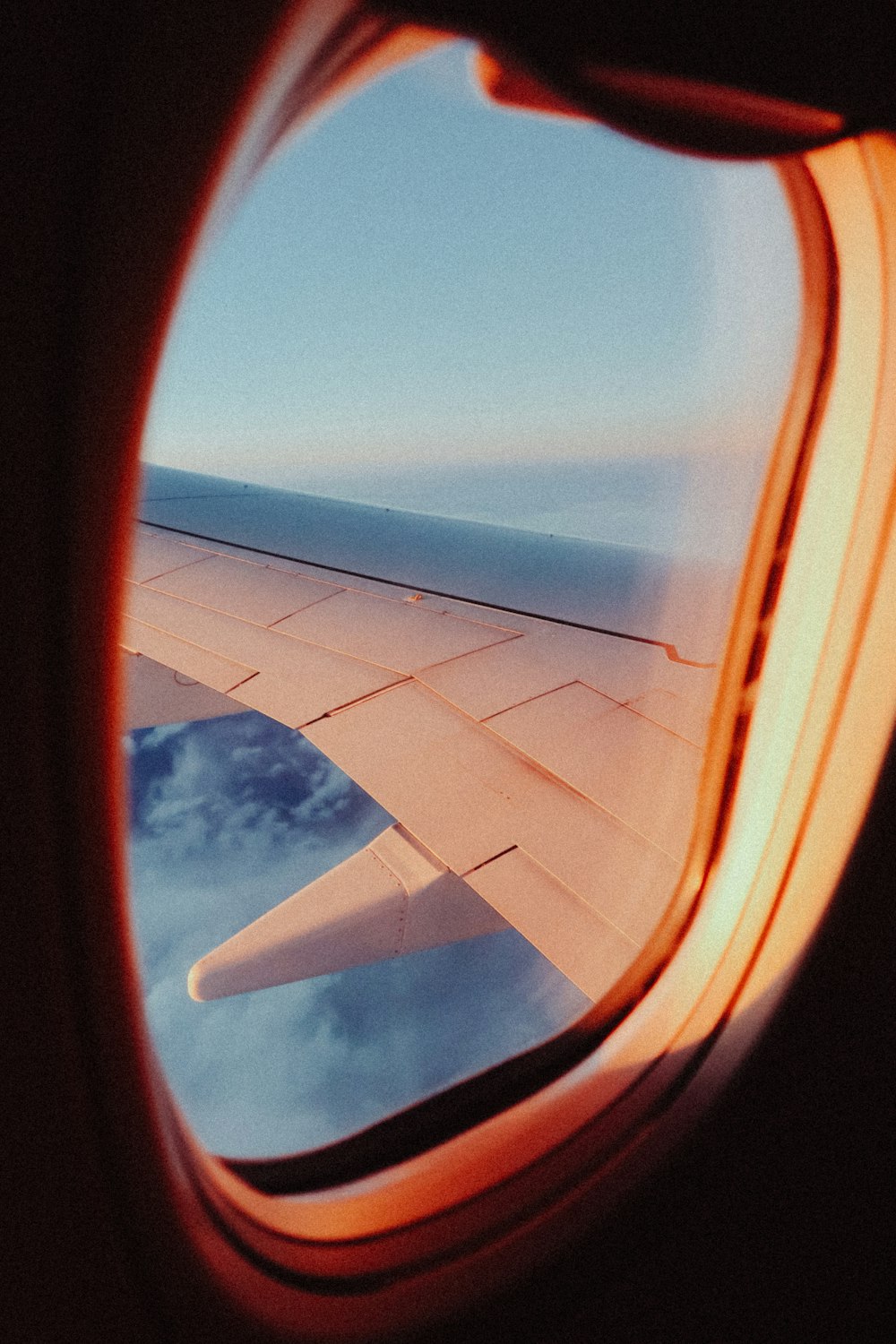 a view of the wing of an airplane through a window