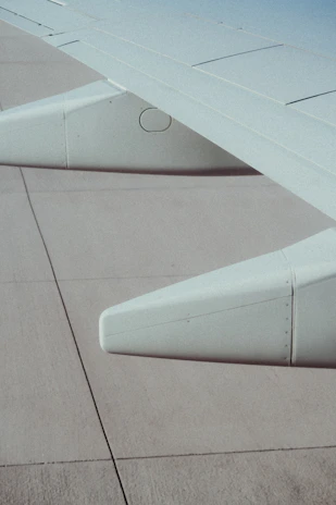 A vibrant close-up of flight control cables and mechanisms inside an aircraft’s wing.