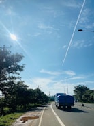 A large cargo truck driving on a highway under a clear sky