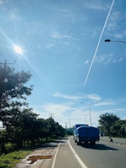 A modern truck on a highway under a clear sky.