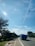 A truck driving on a highway transporting cargo under a clear sky.