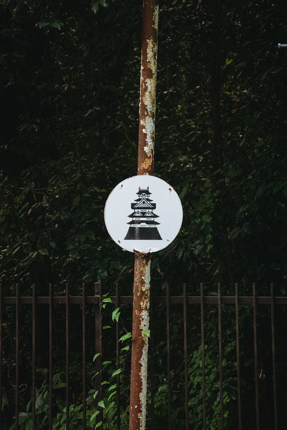 a white sign with a picture of a pagoda on it