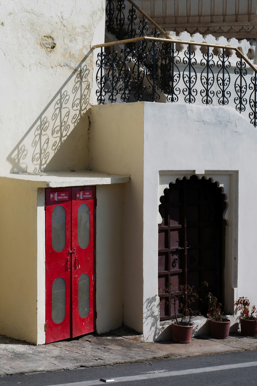 a red door is in front of a white building