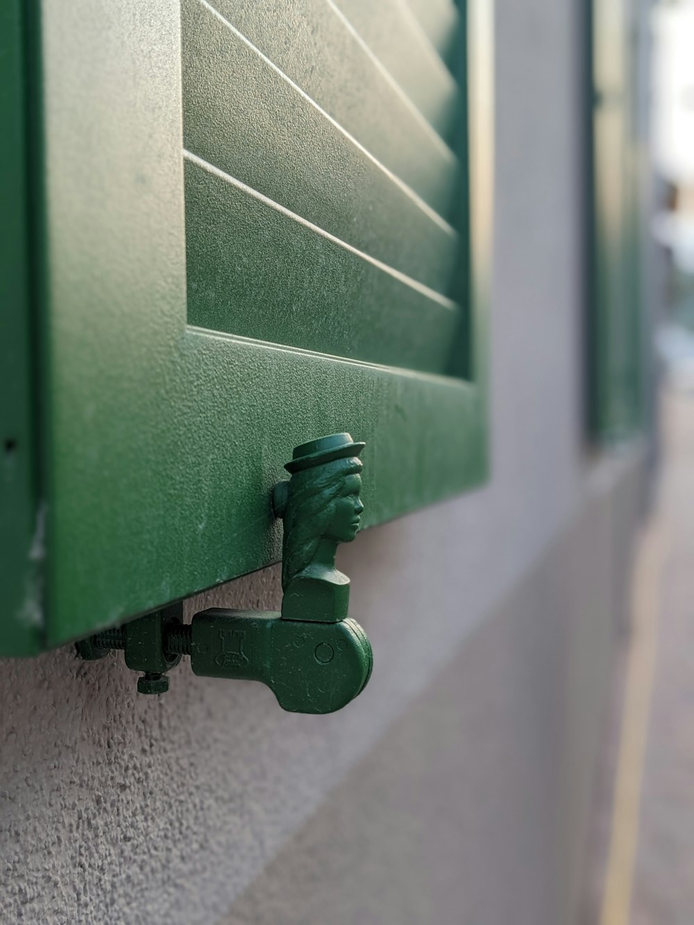 a close up of a green window on a building