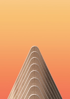 A minimalist architectural structure with a triangular, layered design set against a gradient orange background.