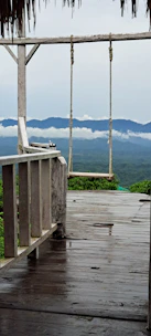 A spacious cabin deck overlooking the canyon with comfortable outdoor seating and morning mist.