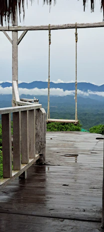 A spacious cabin deck overlooking the canyon with comfortable outdoor seating and morning mist.
