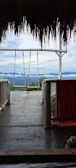 A spacious deck with built-in seating overlooking a mountain view.