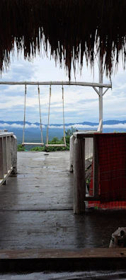 A spacious deck with built-in seating overlooking a mountain view.