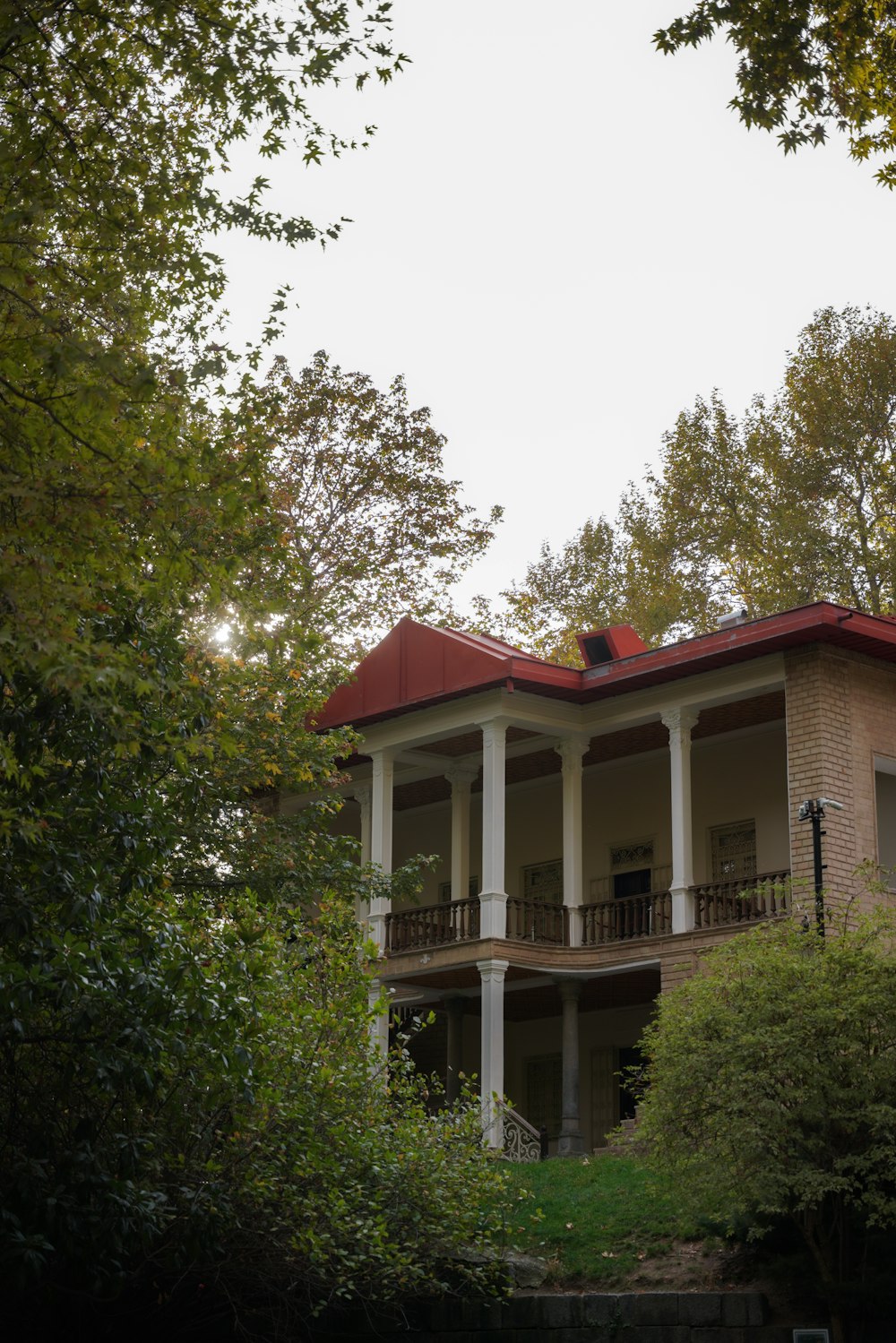 a house with a red roof surrounded by trees