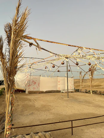 Close-up of a sturdy tent frame with fabric being stretched, highlighting quality craftsmanship.