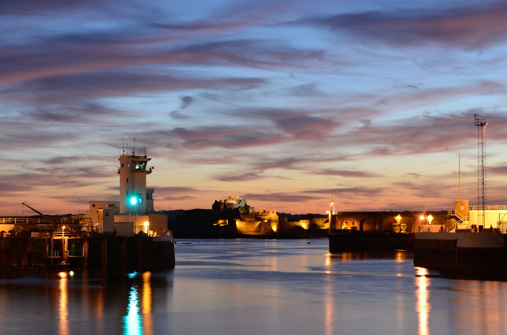 a body of water with a clock tower in the background