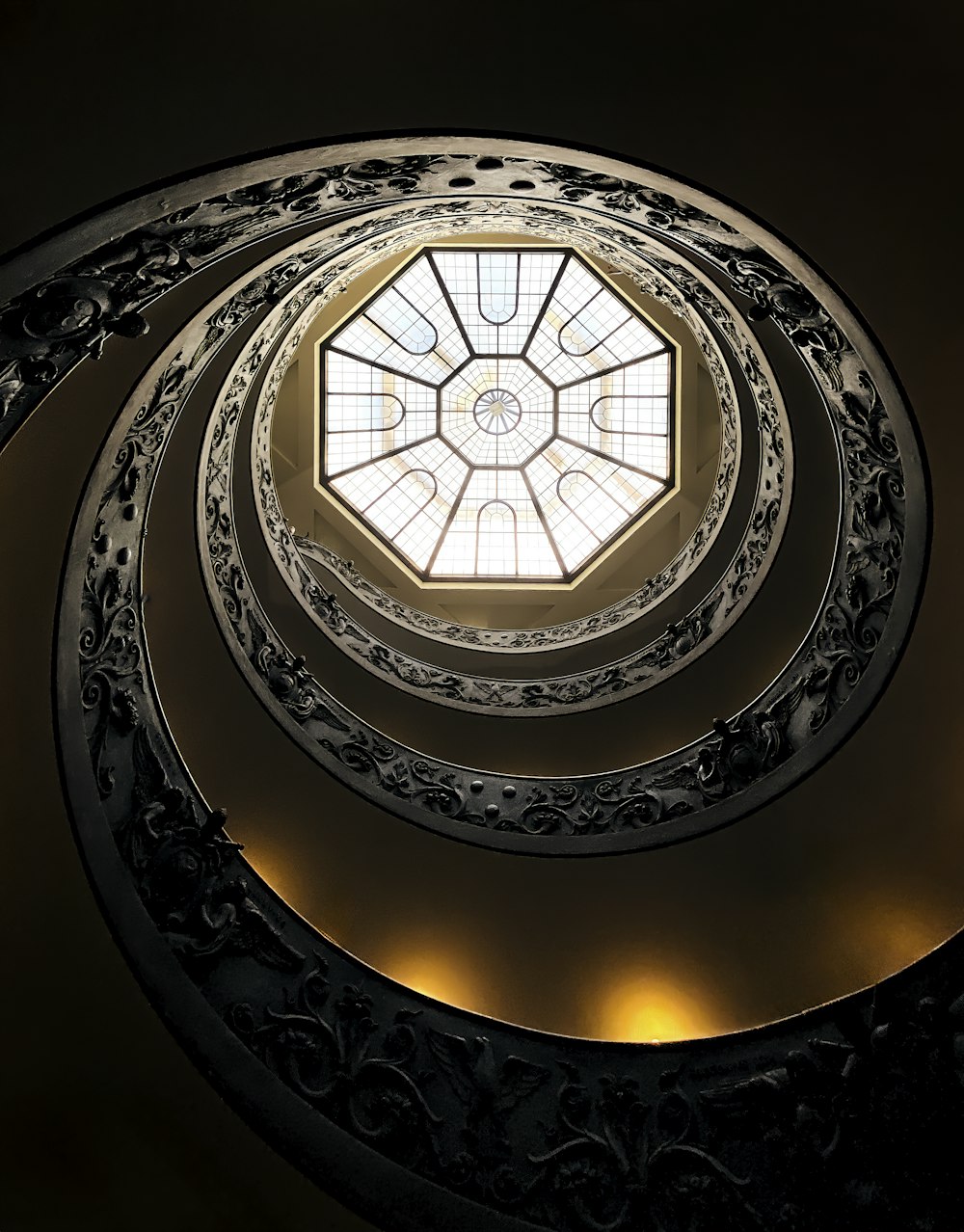 a spiral staircase with a skylight in the center