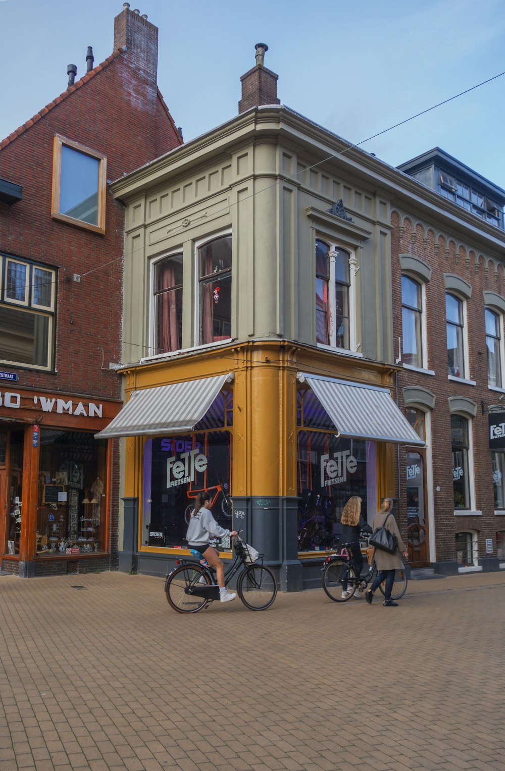 a couple of people riding bikes down a street