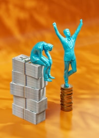 a statue of a man standing on top of stacks of money