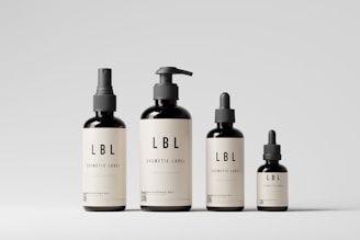 a group of three bottles of liquid on a white surface