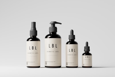 a group of three bottles of liquid on a white surface