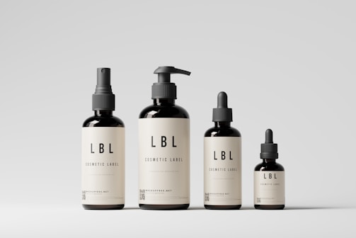 a group of three bottles of liquid on a white surface