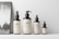 Close-up of delicate cosmetic bottles with soft lighting and a minimalist aesthetic.