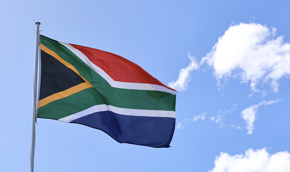 a flag flying in the wind on a sunny day