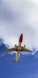 an airplane is flying in the sky with clouds