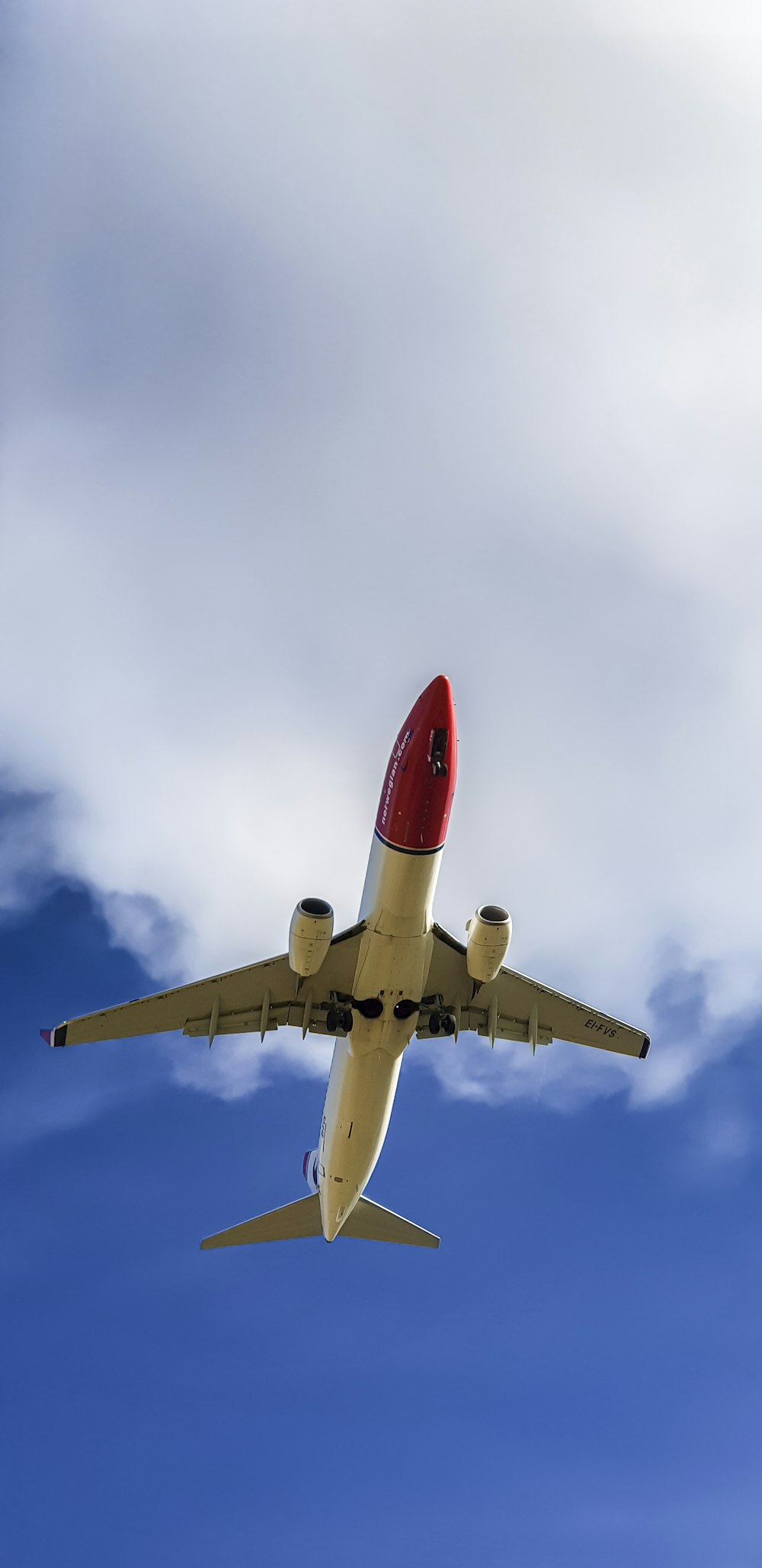 an airplane is flying in the sky with clouds