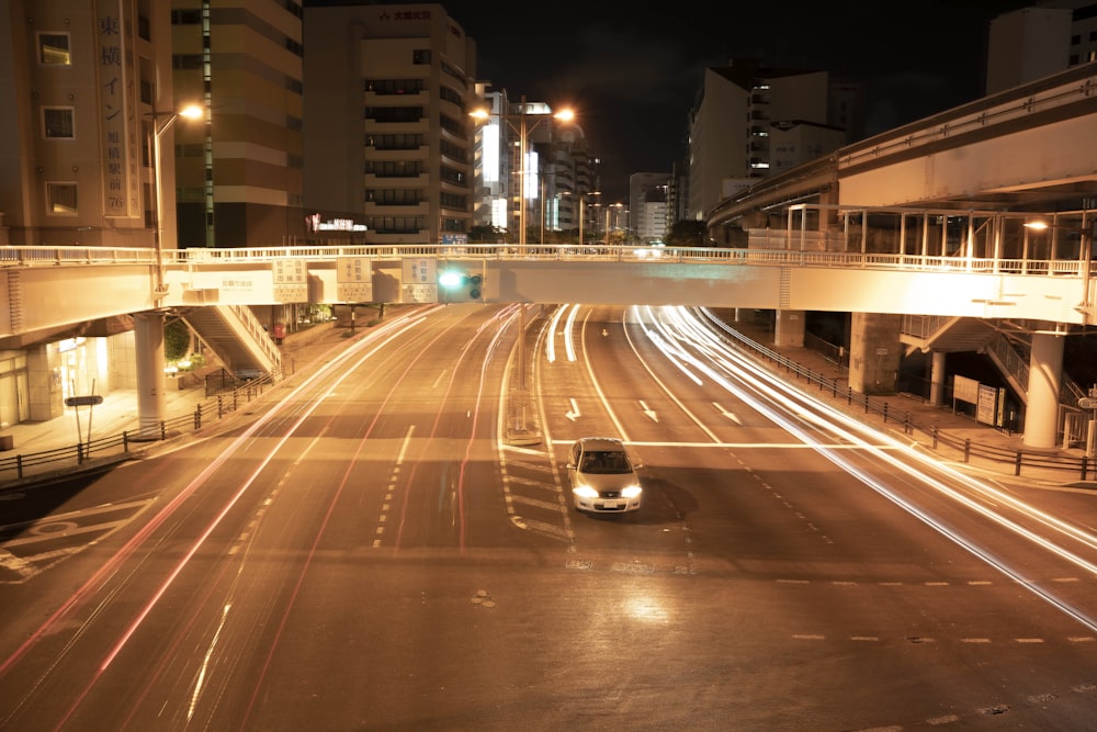 a car driving down a street at night