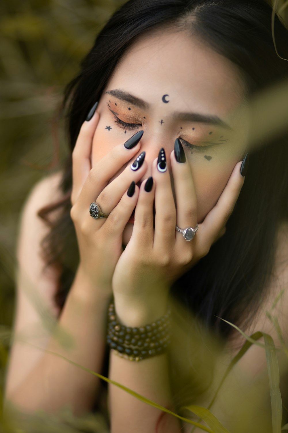 a woman covering her face with her hands