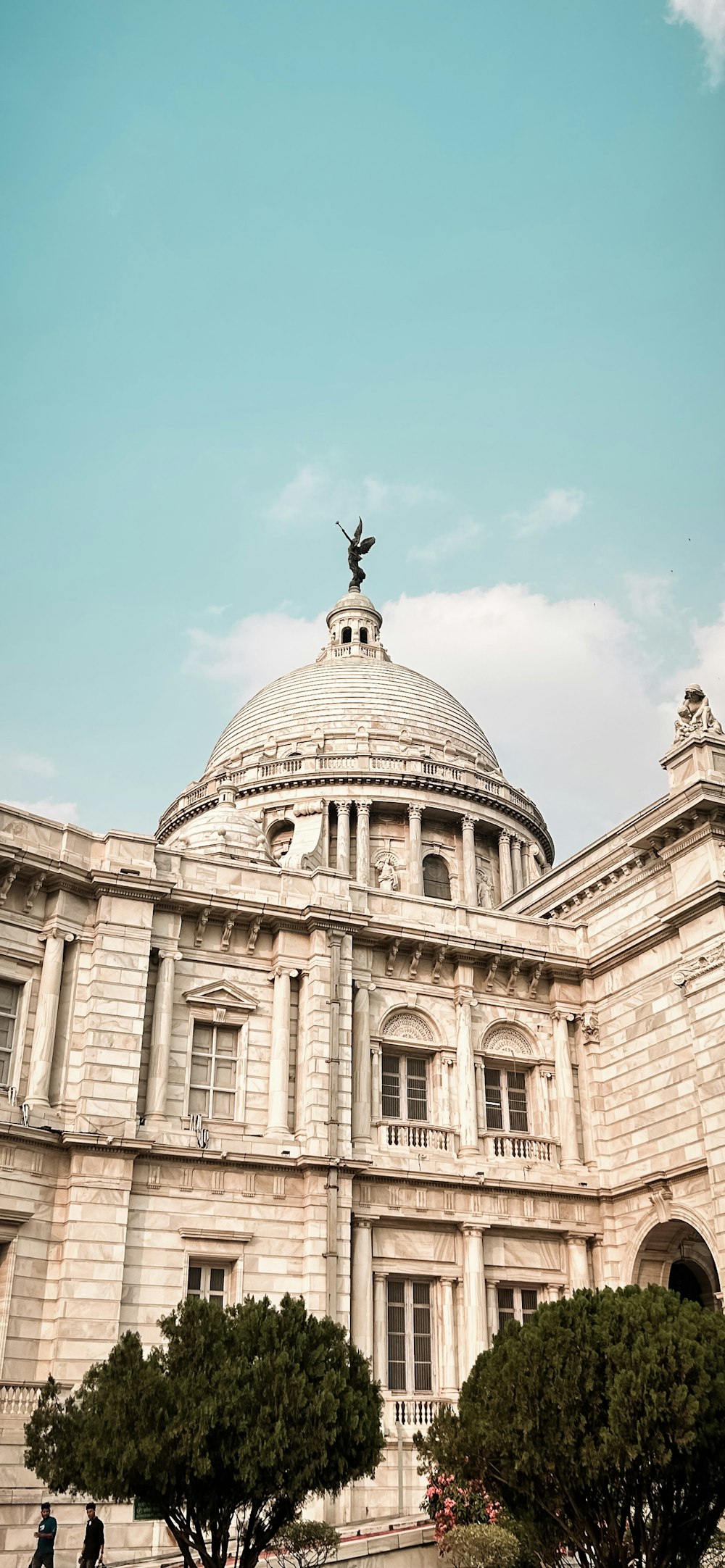 a large building with a statue on top of it