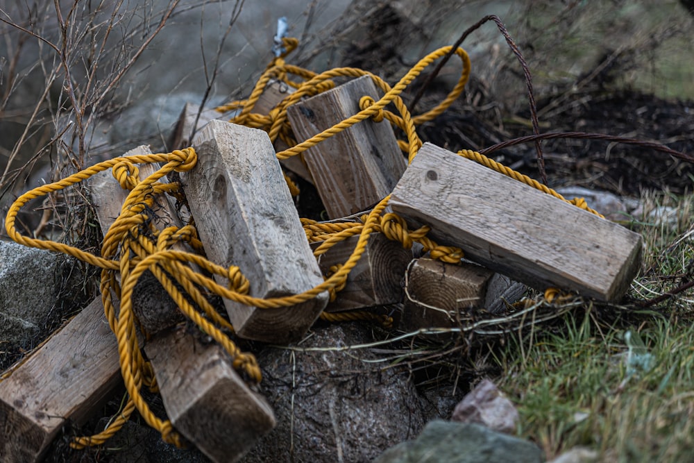 a pile of wood blocks sitting on top of a grass covered field